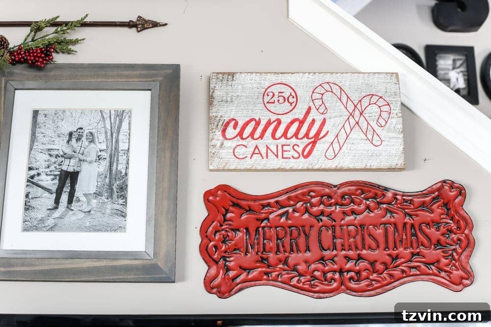 Charming Christmas living room featuring a decorated gallery wall with festive signs, wreaths, and rustic elements.