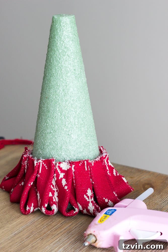 Charming Nordic Knit Mini Christmas Trees 9 DIY Nordic Sweater Mini Christmas Trees | blesserhouse.com - How to make Nordic sweater mini Christmas trees using just florist foam, ribbon, and hot glue for cute decor accents on tabletops and mantels.