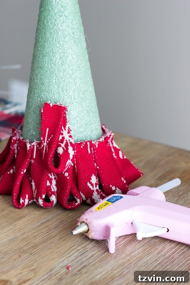Charming Nordic Knit Mini Christmas Trees 10 DIY Nordic Sweater Mini Christmas Trees | blesserhouse.com - How to make Nordic sweater mini Christmas trees using just florist foam, ribbon, and hot glue for cute decor accents on tabletops and mantels.