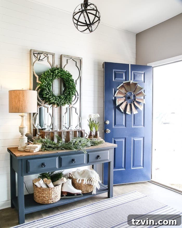 Cozy Winter Foyer Decor Ideas: A beautifully decorated entryway after Christmas, featuring warm lighting, natural elements like greenery and logs, and a welcoming mirror to create an inviting space.