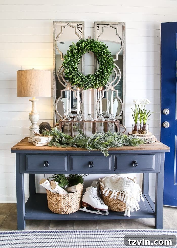 Entryway featuring a decorative mirror, reflecting light and adding a touch of farmhouse glam to the winter decor, enhancing the overall brightness of the space.