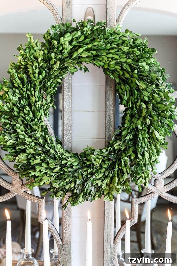 Vibrant artificial greenery and paperwhite flowers beautifully arranged in a winter foyer, adding natural charm and freshness to the entryway decor.