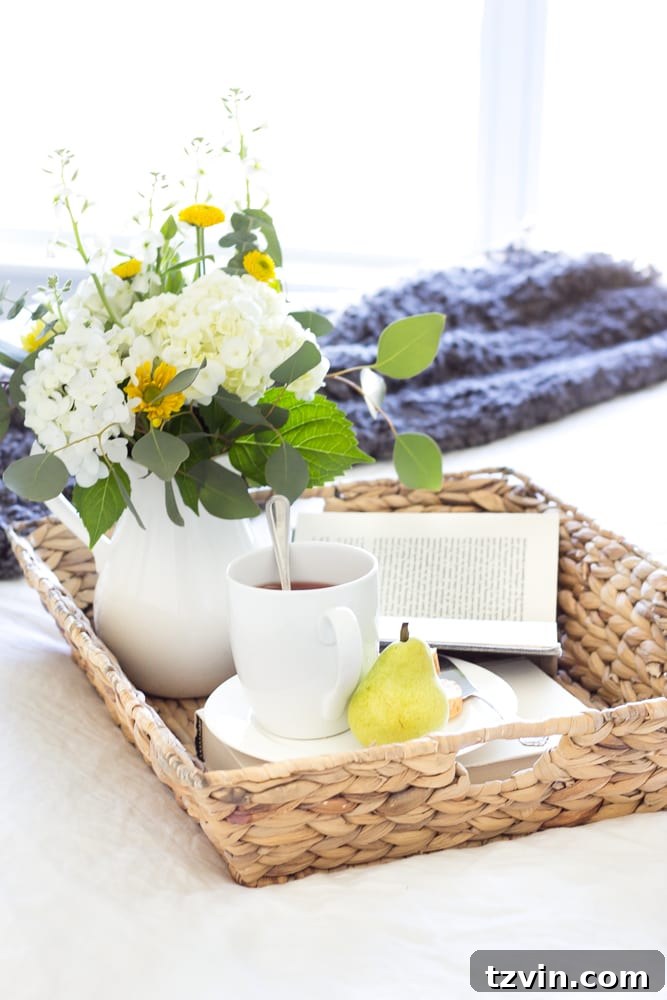 Your Blueprint for a Lightning-Fast Home Sale 17 A staged bed with a tray, coffee cups, and a book, inviting relaxation.