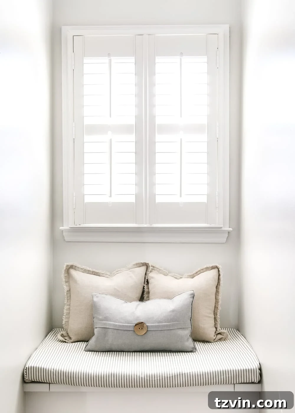 Window seat with ticking stripe cushion and pillows