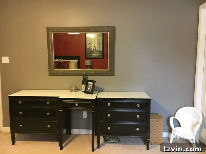 Guest bedroom before with cluttered walls