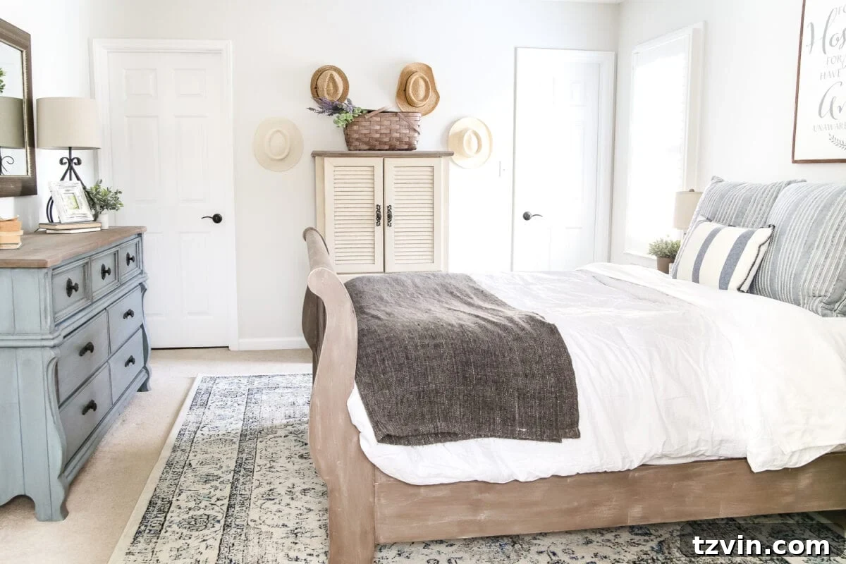 Guest bedroom after with French blue dresser and decorative mirror