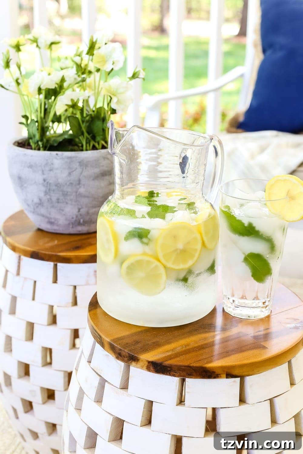 Unlock Your Outdoor Space's Full Potential 5 Outdoor porch featuring a white sofa, blue throw pillows, and two garden stools acting as side tables.