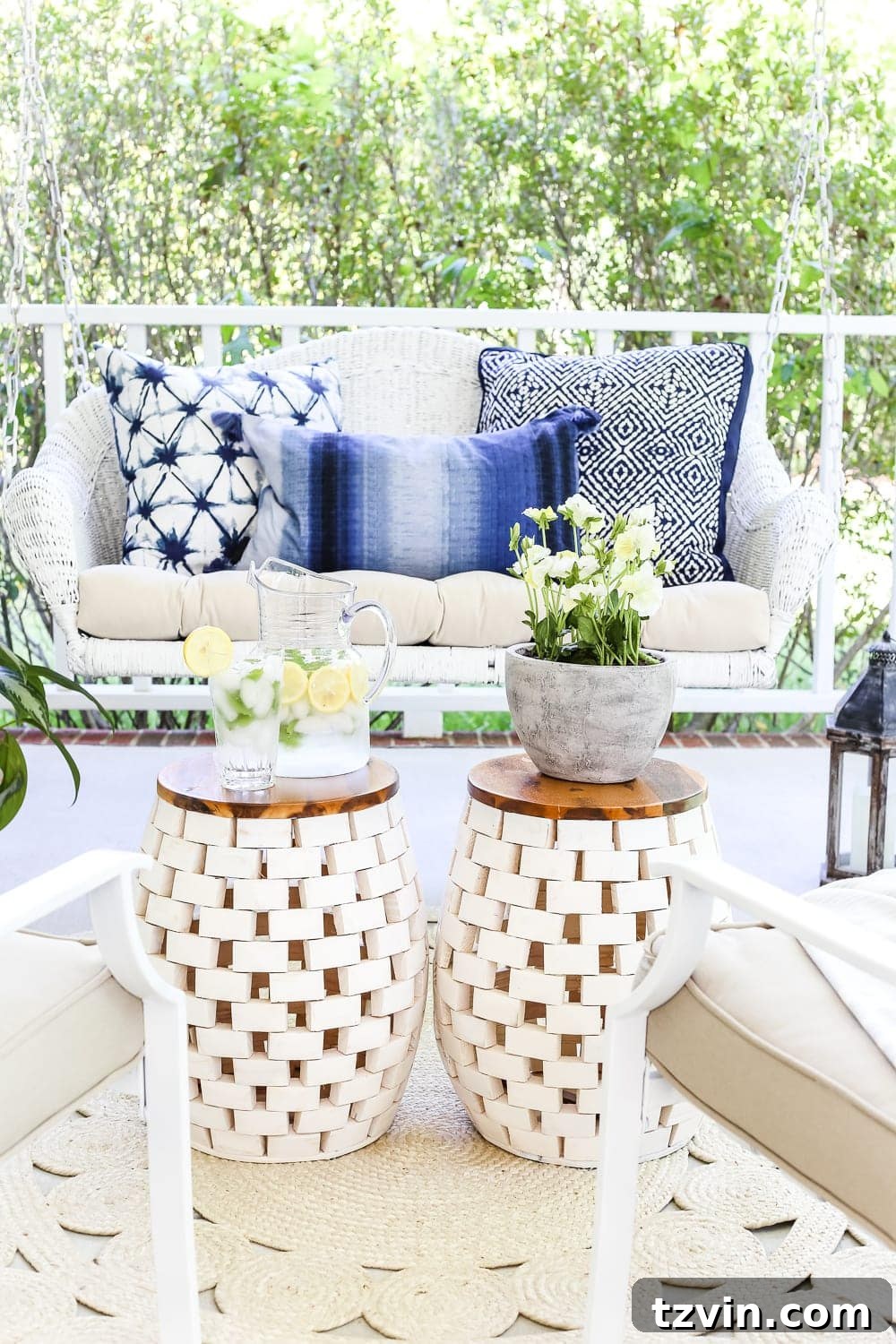 Unlock Your Outdoor Space's Full Potential 6 A wooden garden stool with a white top serves as a coffee table for outdoor seating, styled with a small vase and a book.