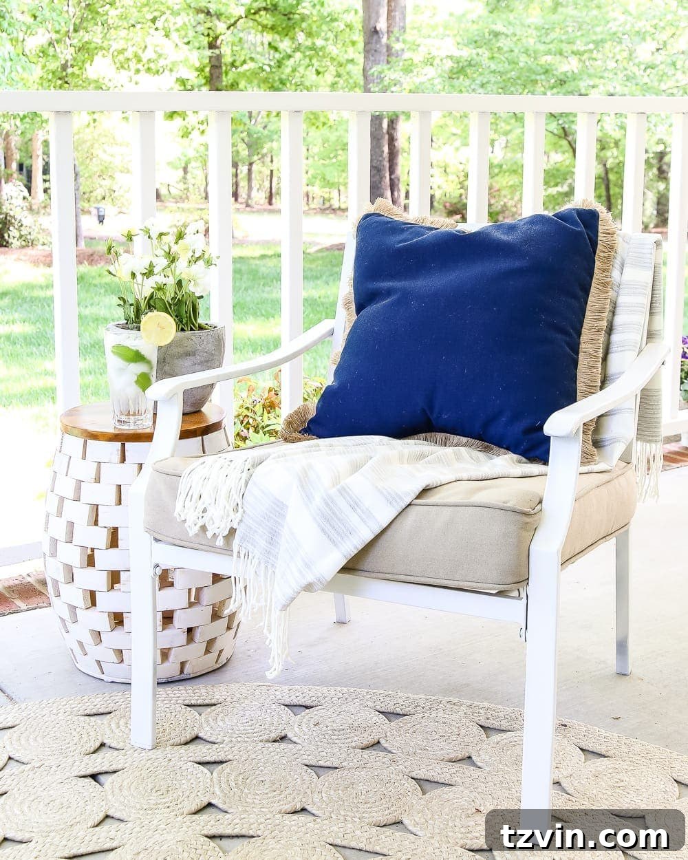 Unlock Your Outdoor Space's Full Potential 7 Close-up of a blue drink in a glass placed on a white garden stool, functioning as a stylish outdoor side table.