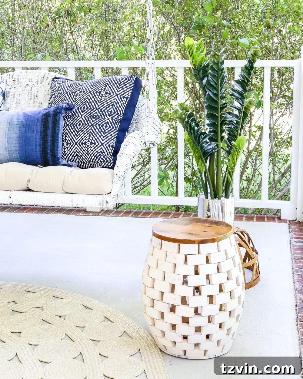Unlock Your Outdoor Space's Full Potential 8 A wooden garden stool with a white top, used as additional seating on a cozy outdoor porch with white rocking chairs.