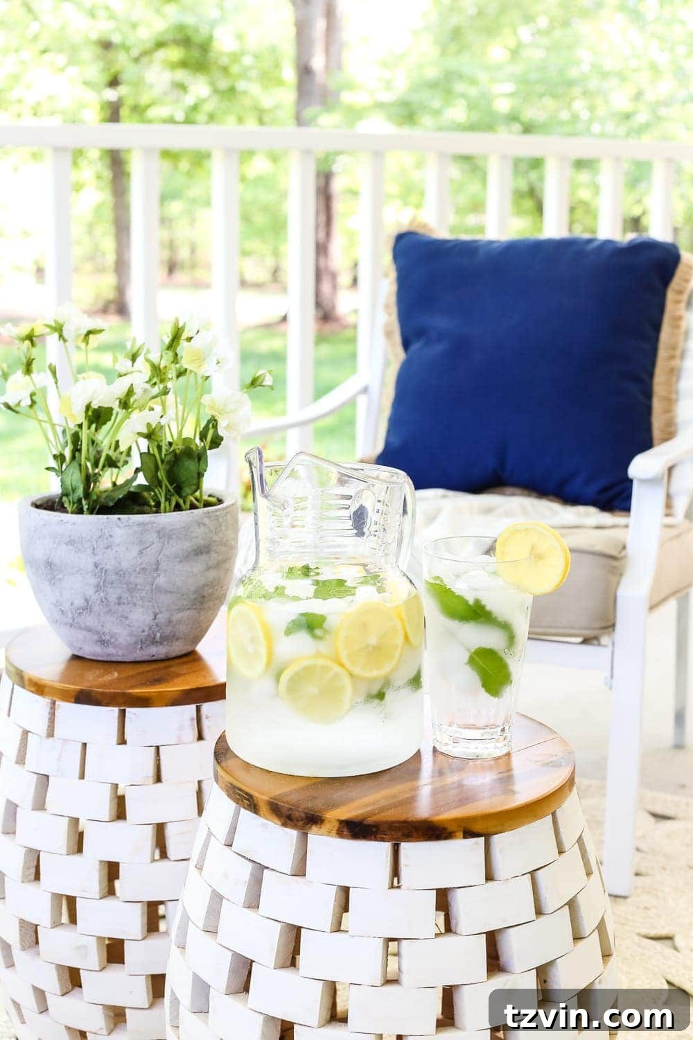Unlock Your Outdoor Space's Full Potential 9 A close-up of a white and wood acacia garden stool, showcasing its stylish design on an outdoor porch.