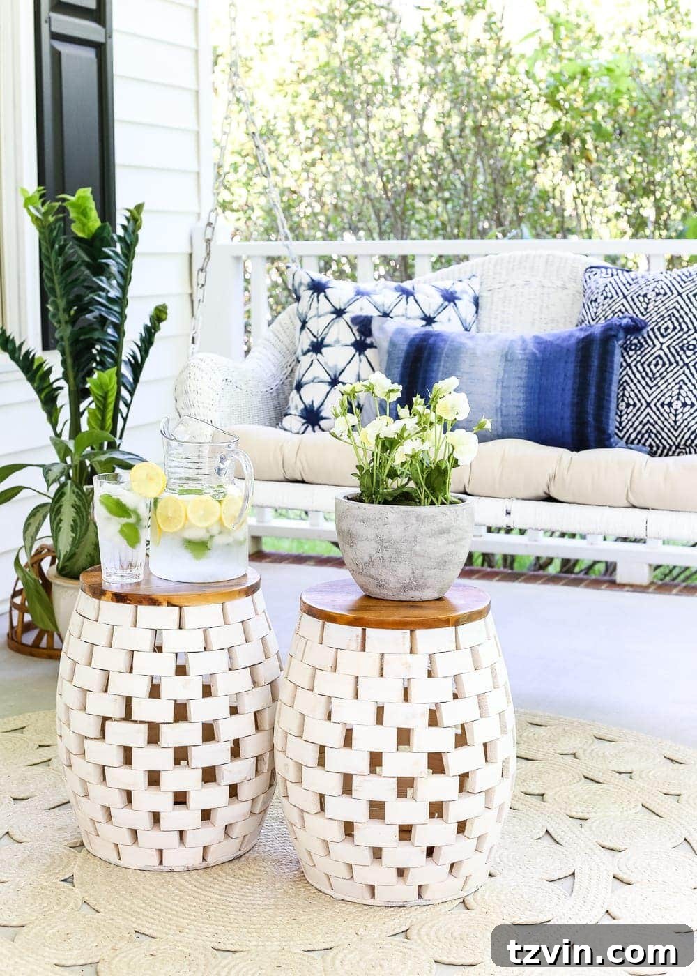 Unlock Your Outdoor Space's Full Potential 10 Cozy outdoor porch decor featuring a striped throw blanket draped over a white rocking chair, next to a garden stool.