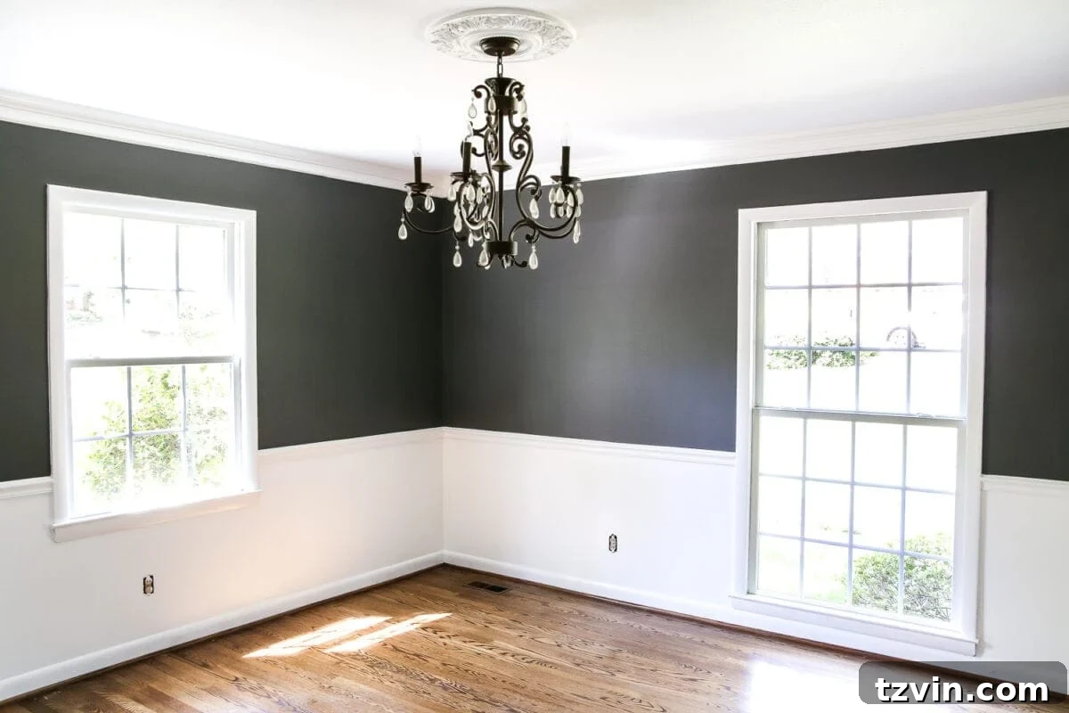 Dining Room After Paint | blesserhouse.com - A high contrast dining room featuring Benjamin Moore Simply White below the chair rail and Kendall Charcoal above, creating a moody and elegant atmosphere.