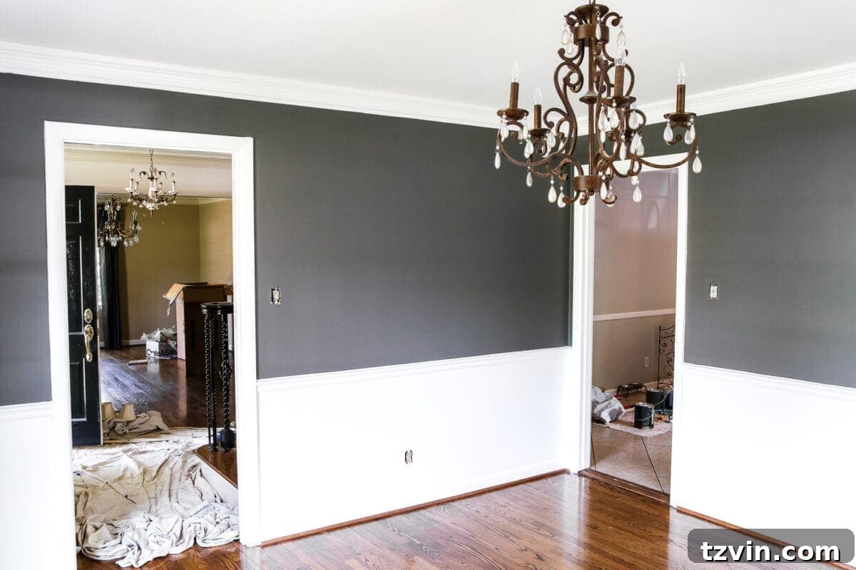 High Contrast Dining Room Details | blesserhouse.com - Close up of a dining room wall showcasing Benjamin Moore Simply White and Kendall Charcoal with a chair rail, hinting at a new elegant design.
