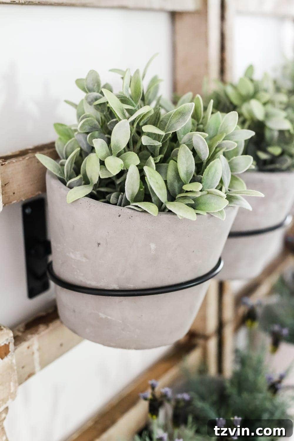 Upcycled Banister Wall Planter 5 Three cement pots with vibrant artificial plants displayed on a repurposed antique banister wall planter in a breakfast nook