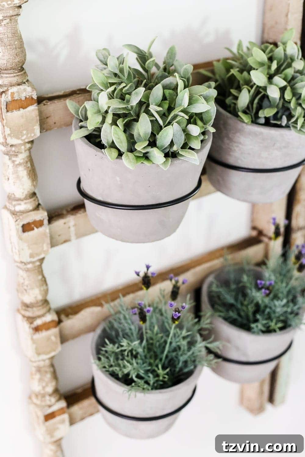 Upcycled Banister Wall Planter 9 Detailed shot of the repurposed banister, cement pots, and lifelike artificial plants, emphasizing the rustic elegance of the DIY project
