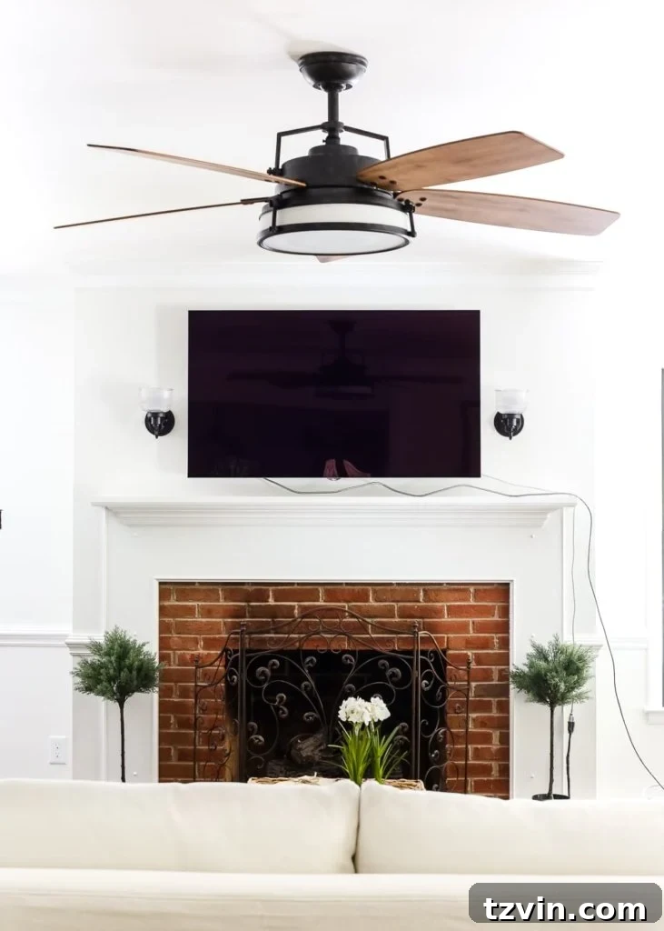 Living Room Refresh A Stylish Spin 3 Close-up of the stylish Casablanca Caneel Bay ceiling fan, highlighting its unique raw wood blades and aged steel finish.