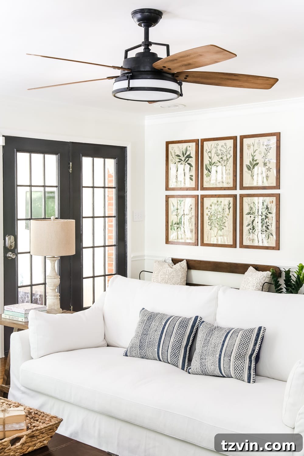 A Modern French Farmhouse Summer Retreat 9 Modern French Farmhouse Living Room with Blue Pillows - A summer home tour featuring modern French farmhouse style, inexpensive decorating tricks, and ways to make your home look luxurious on a budget.