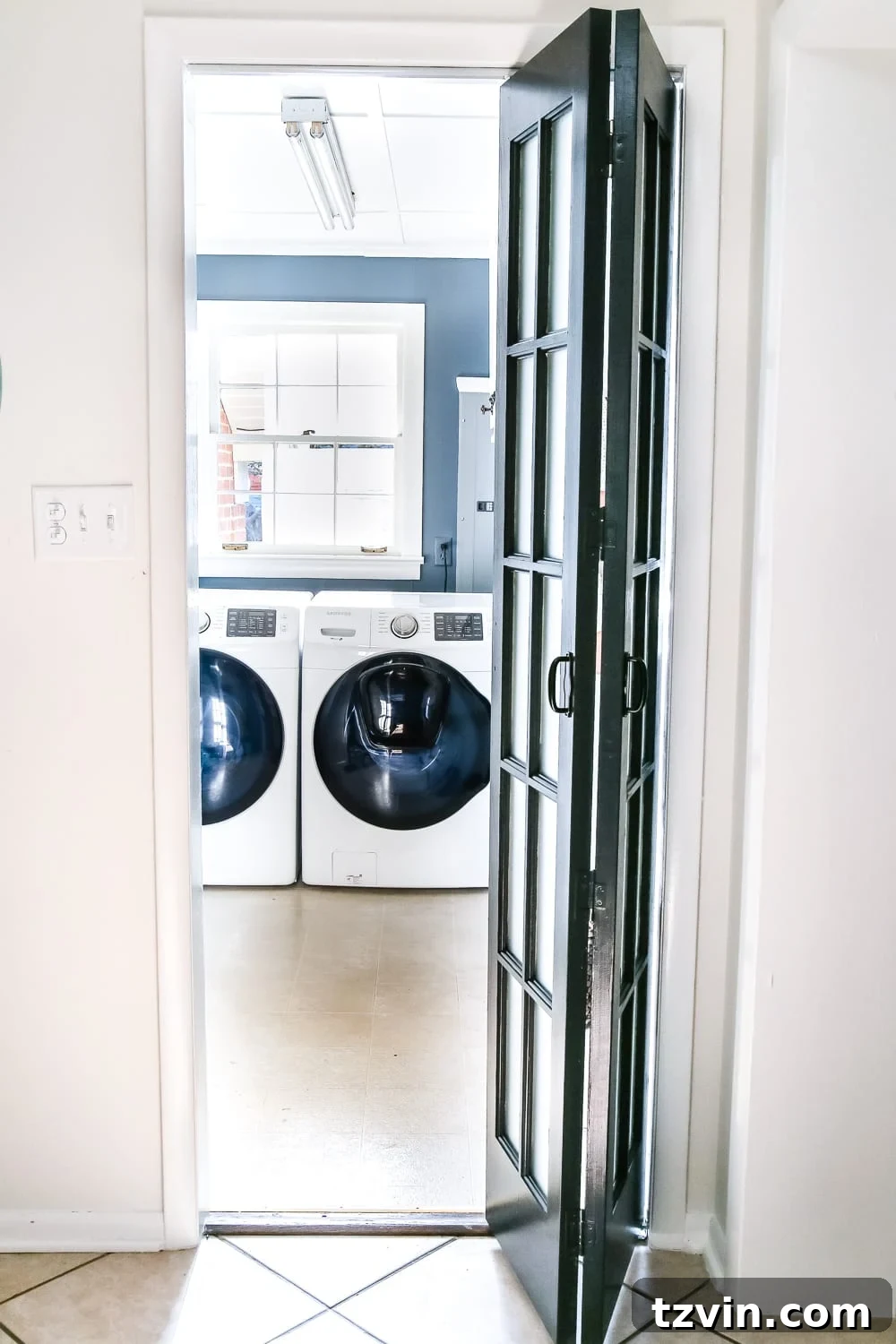 Laundry Room Updates: French Bifold Door | blesserhouse.com - A rickity laundry room bifold door gets a beautiful and functional update with a French bifold door with frosted glass for hiding messes in a stylish way.