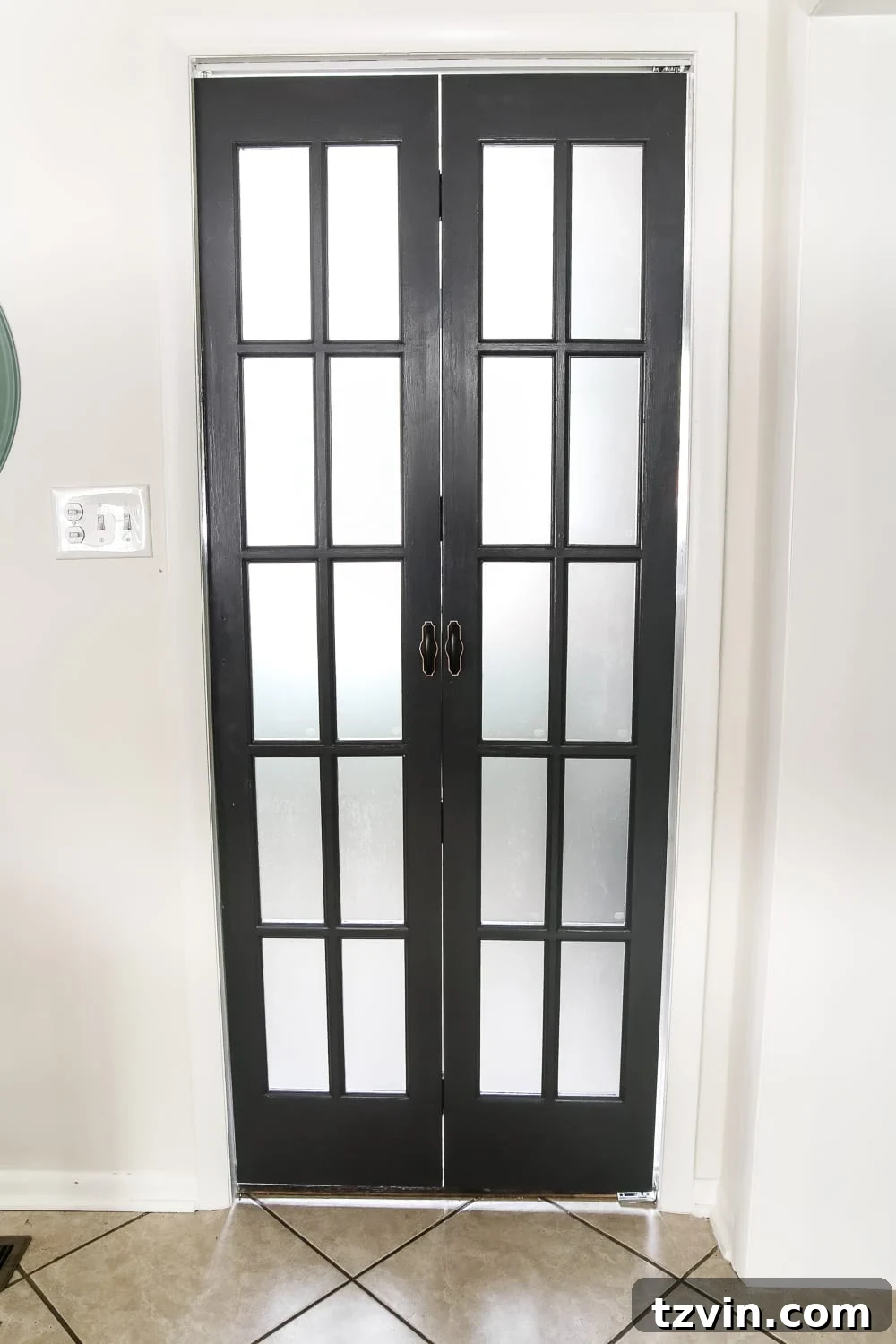 Laundry Room Updates: French Bifold Door | blesserhouse.com - A rickity laundry room bifold door gets a beautiful and functional update with a French bifold door with frosted glass for hiding messes in a stylish way.