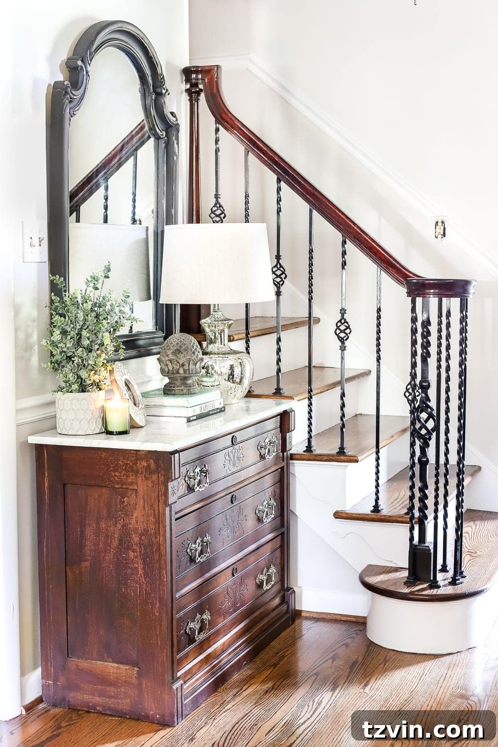 Foyer View with Victorian Chest and Staircase