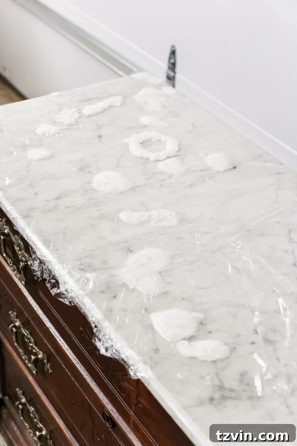 Applying Baking Soda Paste and Covering with Plastic Wrap