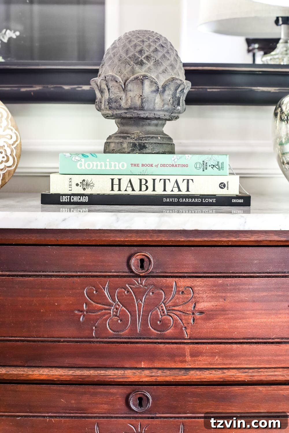 Decorative Items on Marble Top: Books and Concrete Statuette