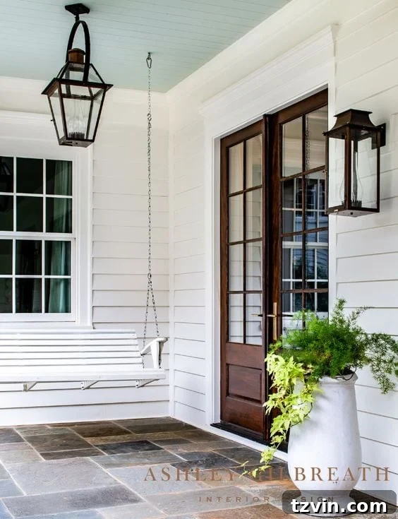 porch with wooden door and white bench swing