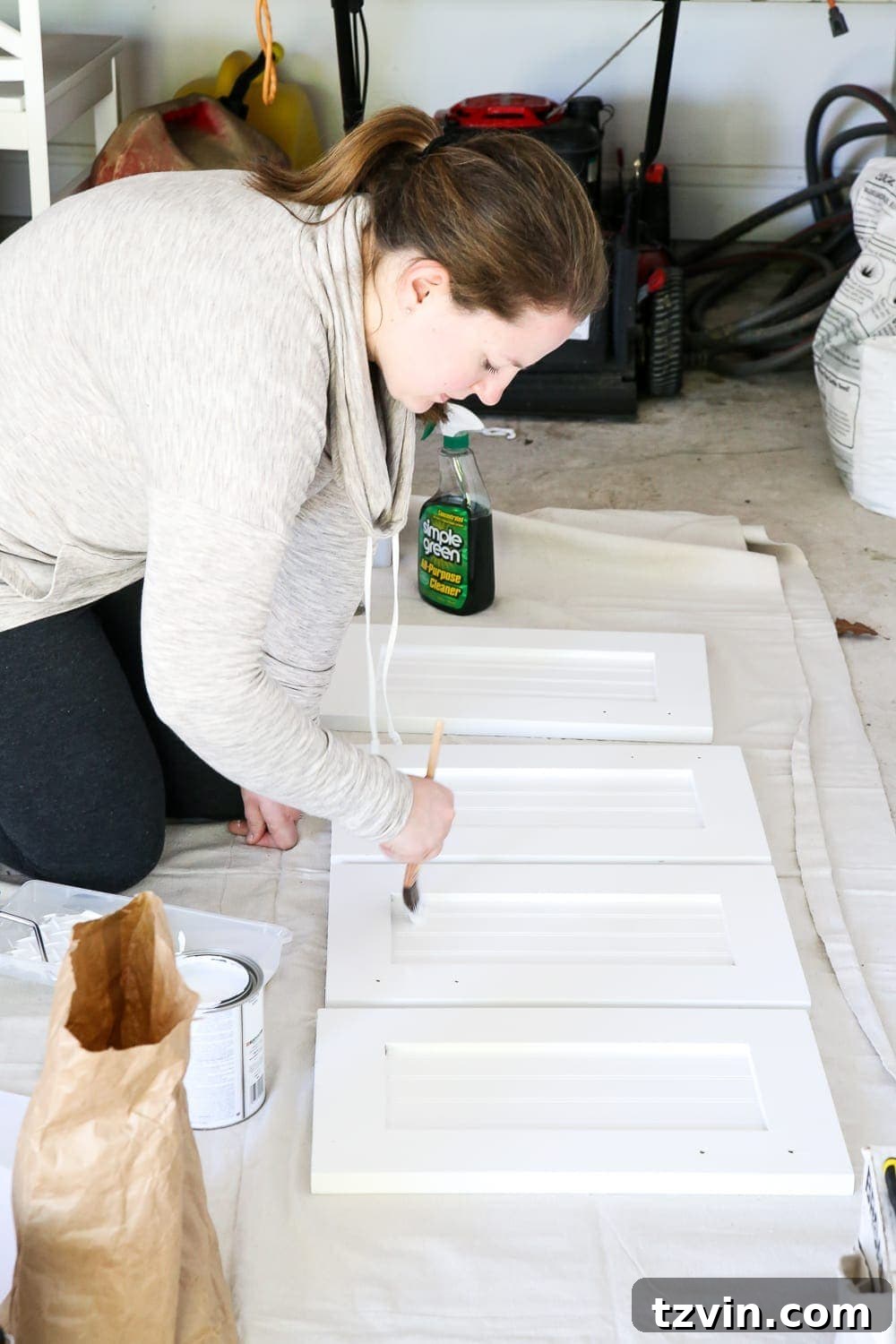 Lowes Bathroom Remodel Showcase 6 Nina expertly paints the bathroom vanity cabinets, a key step in the transformation.