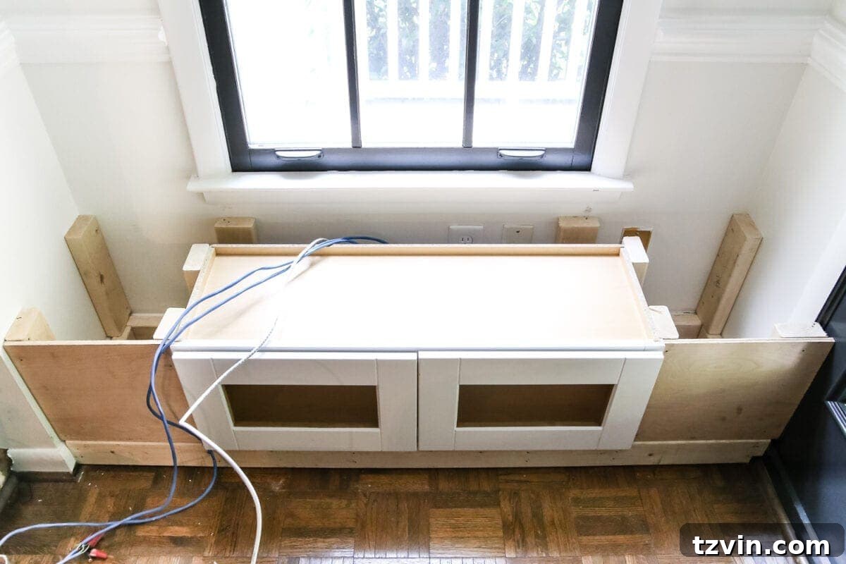 Kitchen Cabinet Window Seat Transformation 10 DIY Window Seat from a Kitchen Cabinet | blesserhouse.com - A simplified tutorial for how to build a DIY window seat using a prefabbed kitchen cabinet to house electronics and hide cords.