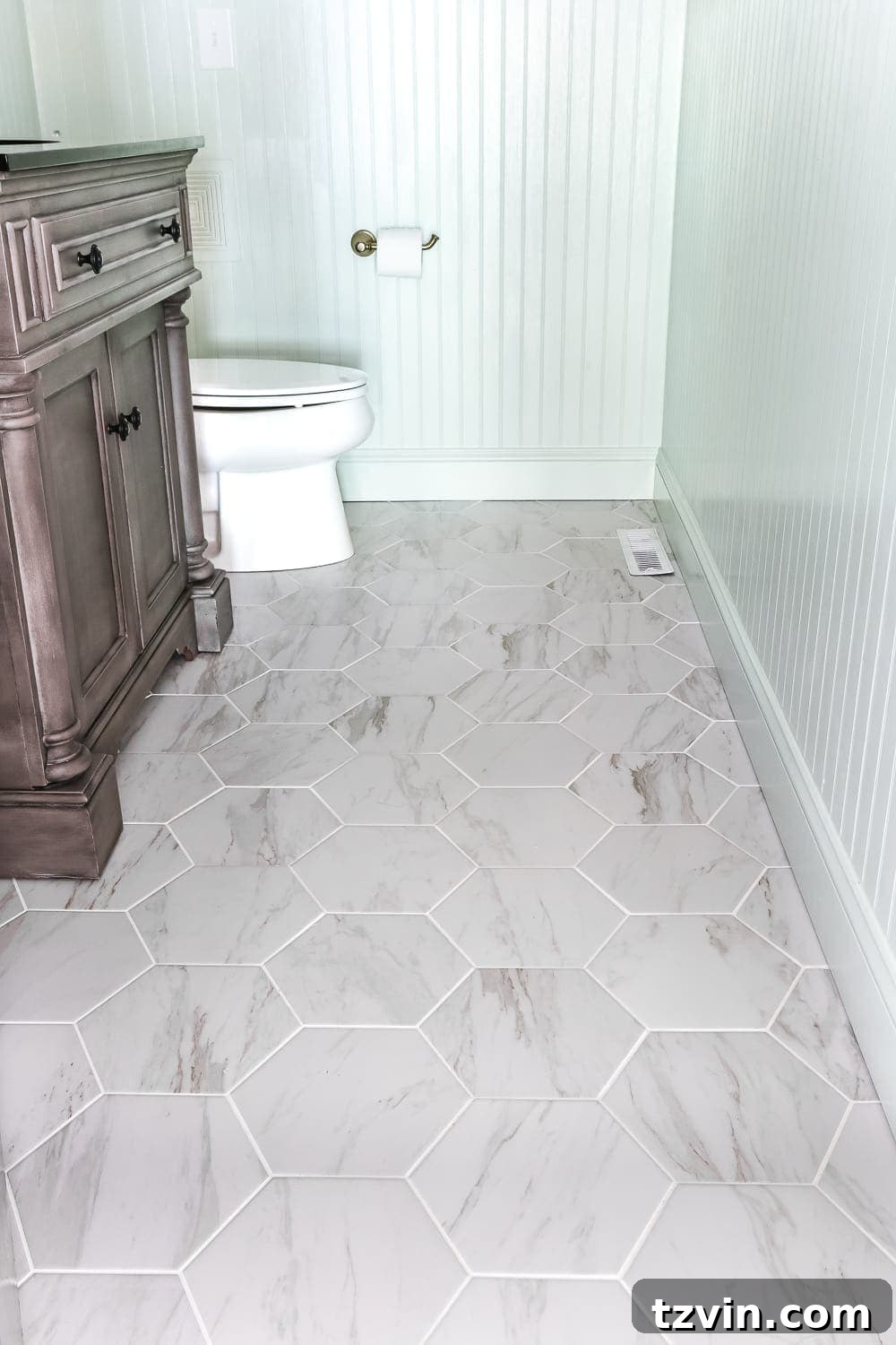 Marble Look Hexagon Tiles Powder Room | blesserhouse.com - A dated powder room gets a modern meets traditional, urban meets farmhouse makeover with aquas, black and white, and antique brass. 