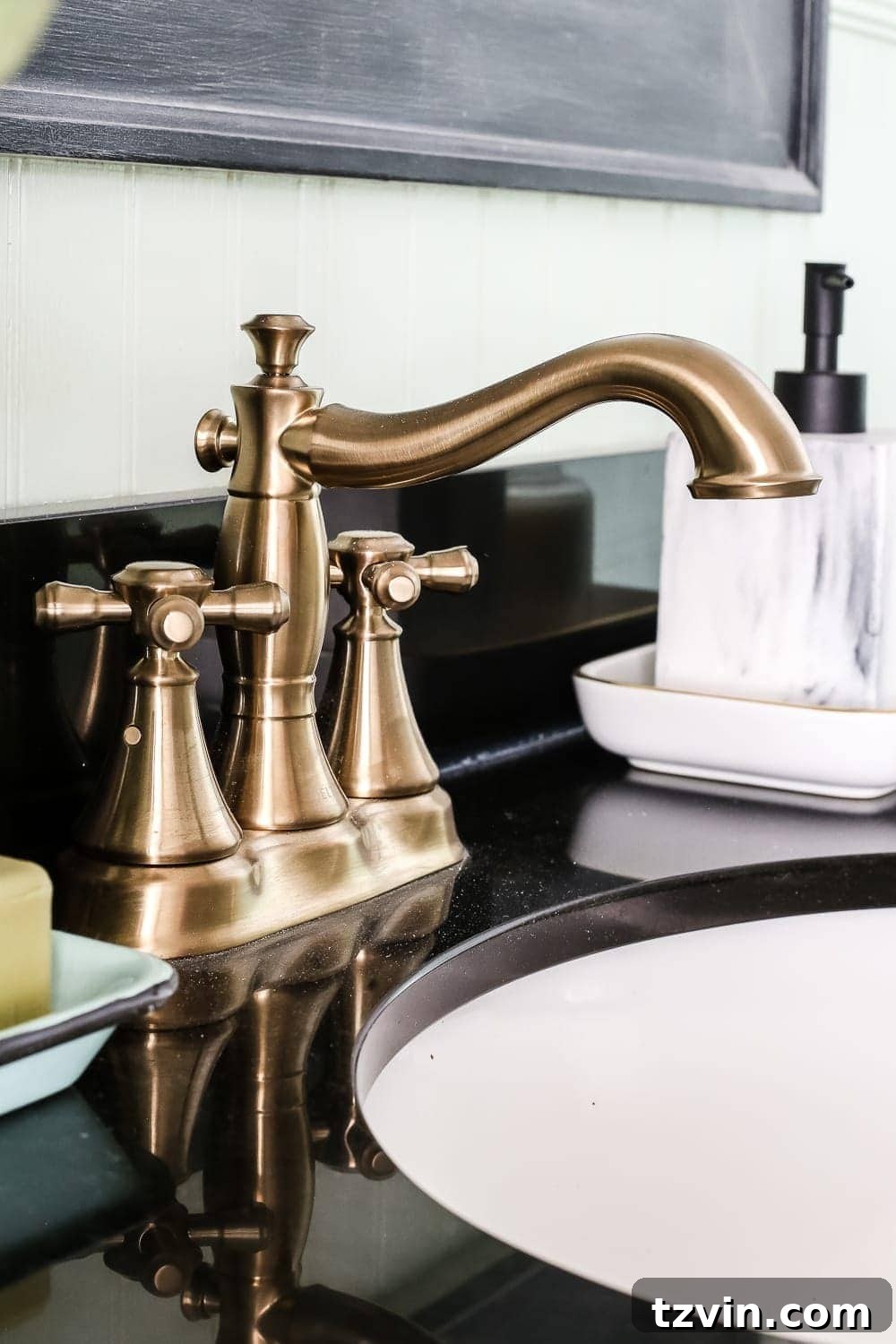 Champagne Bronze Faucet Detail | blesserhouse.com - A dated powder room gets a modern meets traditional, urban meets farmhouse makeover with aquas, black and white, and antique brass. 