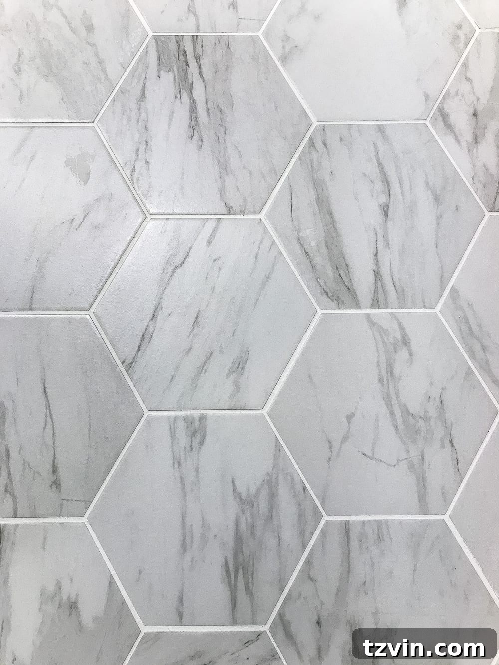 Powder Room Radiance: Faux Marble Tile Floor Upgrade 8 Close-up of the new faux marble hexagon tile floor, highlighting the intricate pattern and realistic veining that gives it the appearance of genuine Carrara marble.
