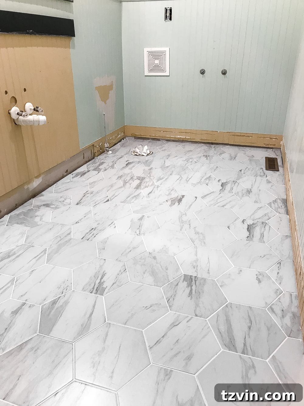 Powder Room Radiance: Faux Marble Tile Floor Upgrade 10 A closer look at the new faux marble hexagon tile and the progress of the powder room renovation, illustrating the transition from a messy construction zone to a beautifully updated space.