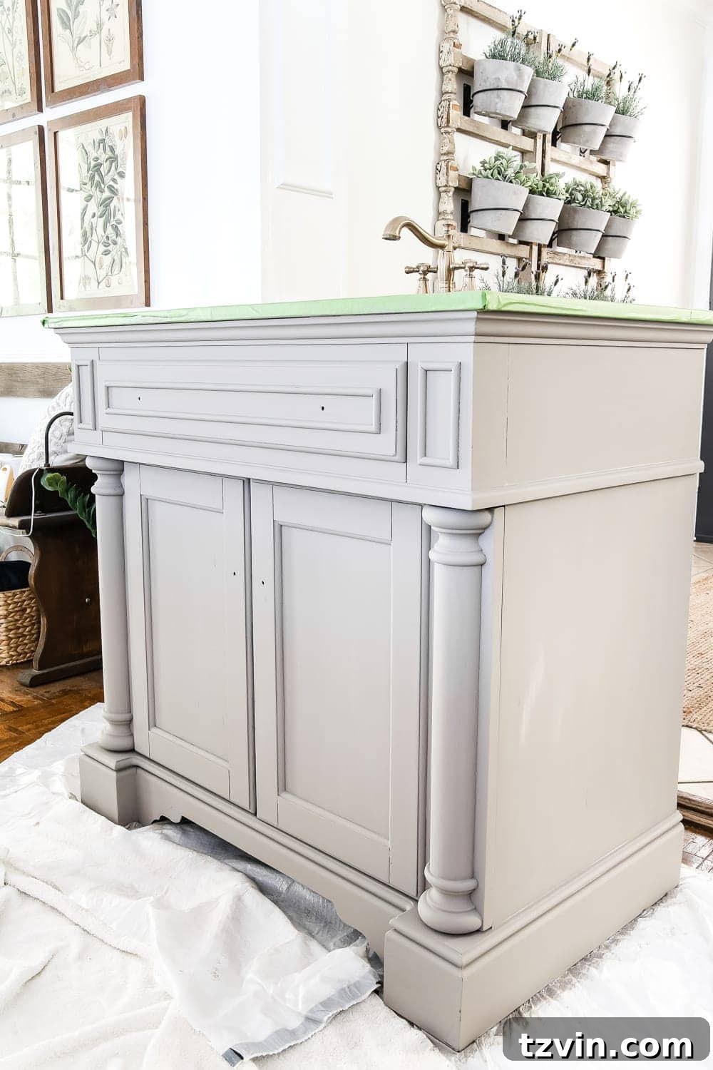 Rustic Gray Wood Vanity Transformation 3 Applying the first coat of Annie Sloan French Linen chalk paint to the vanity surface.