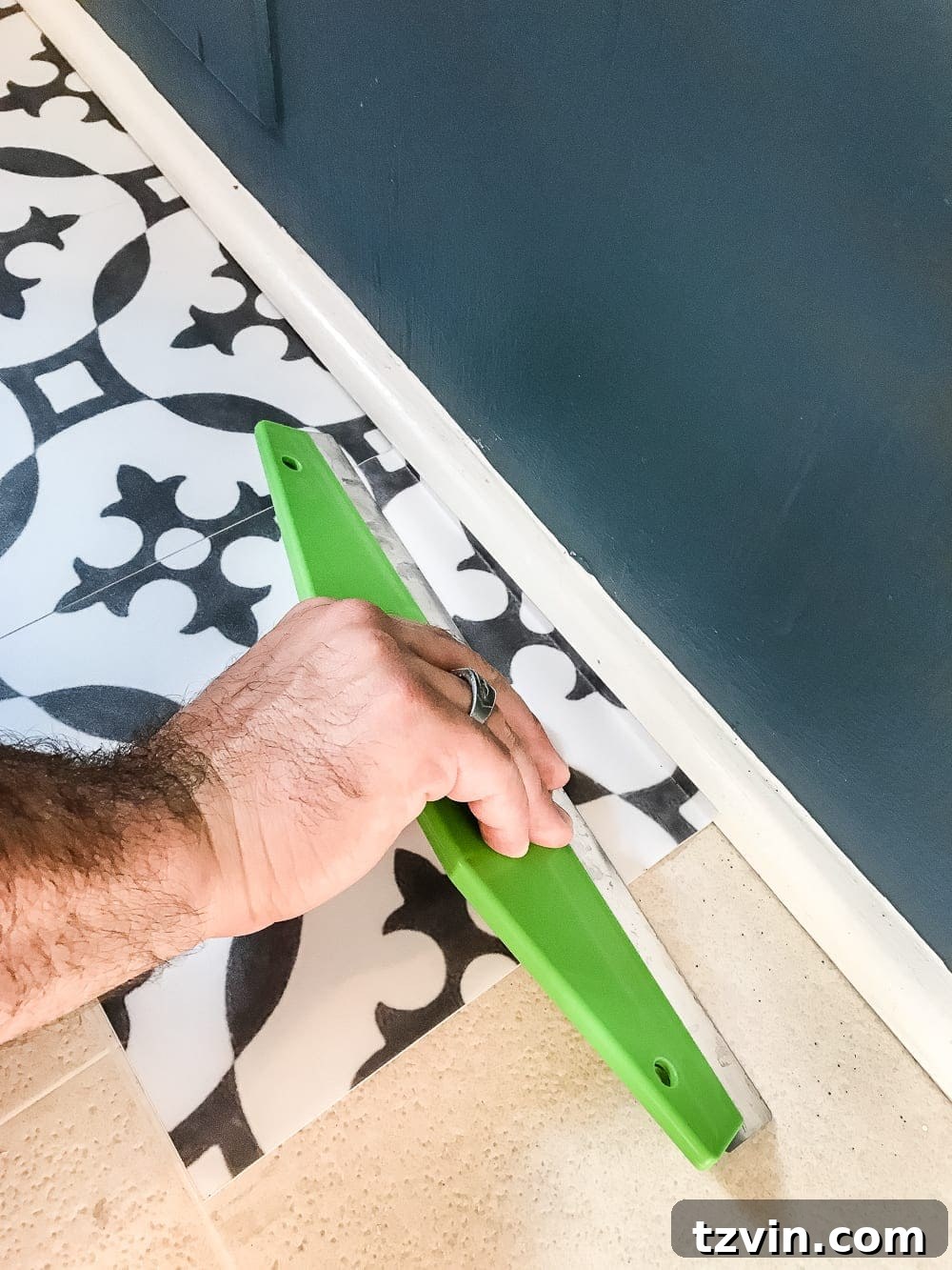 Starting the installation of Moroccan peel and stick vinyl tiles under appliances.