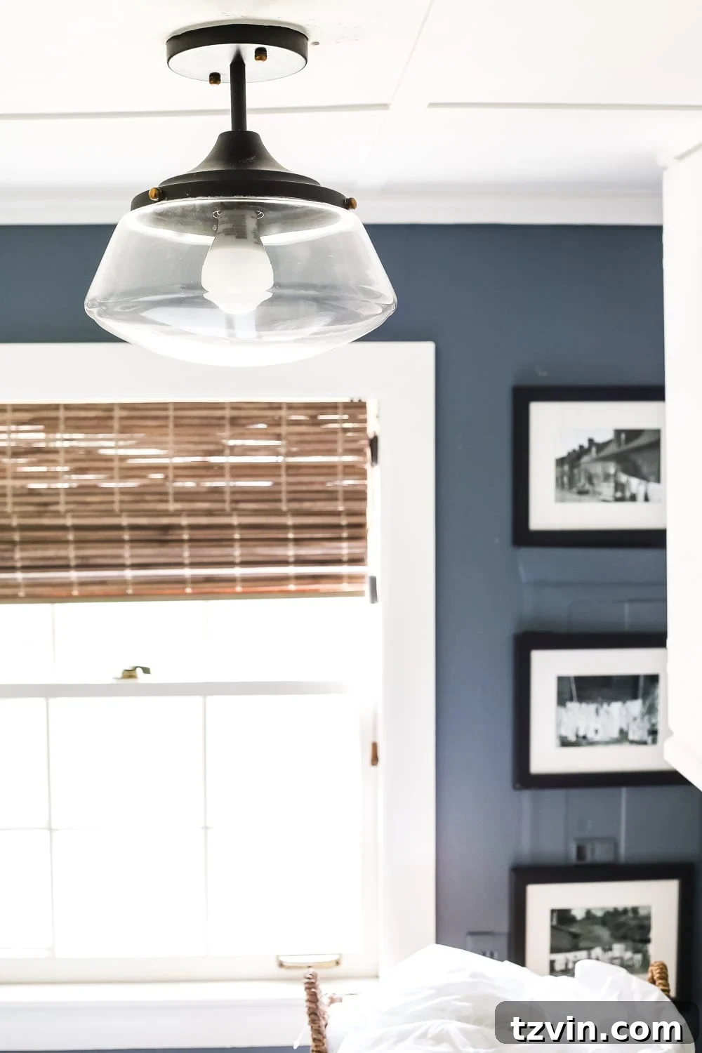 Bold Contrast Laundry Room Transformation 11 Stylish vintage-style semi-flush mount light fixture in a modern laundry room.