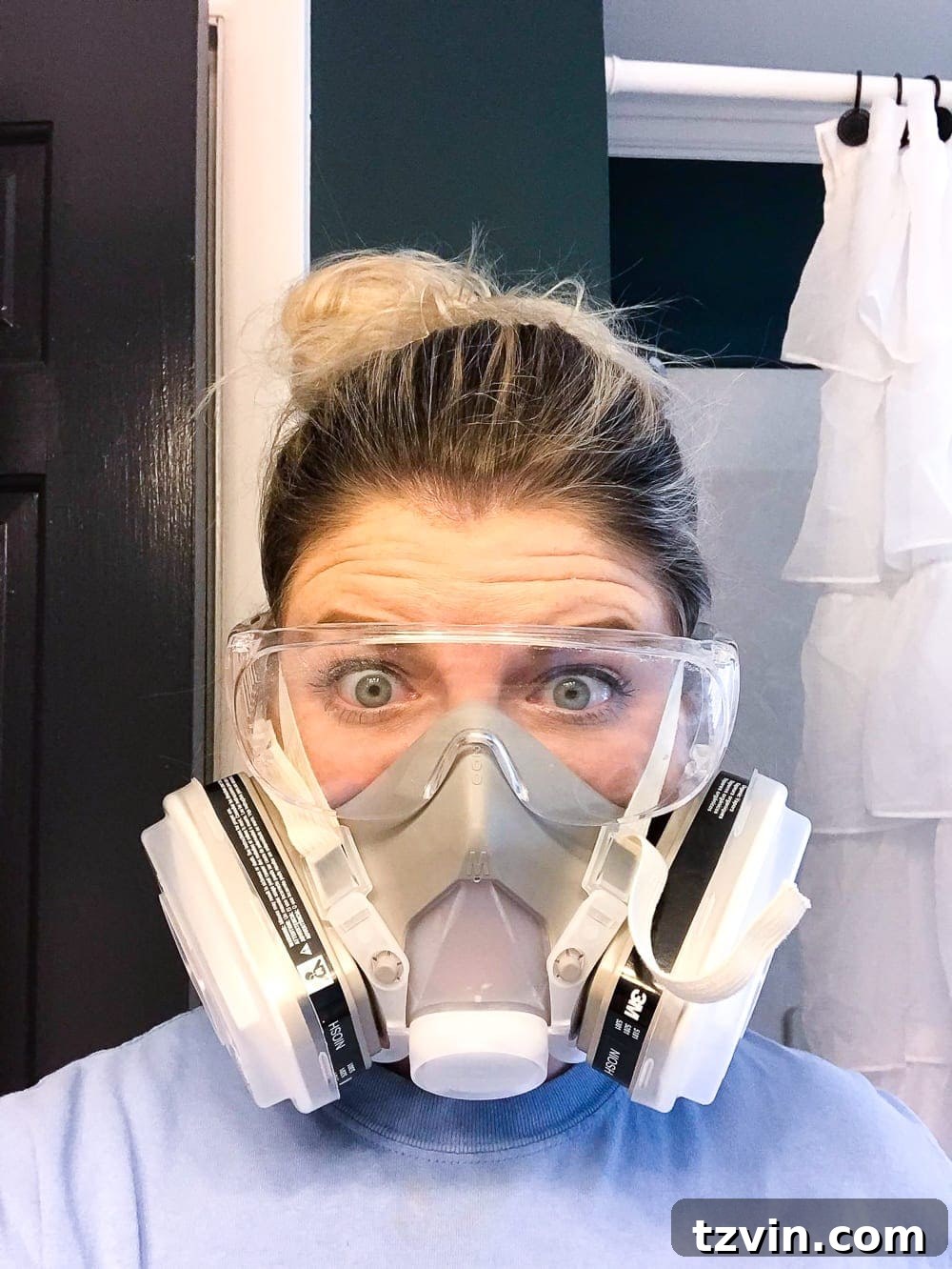 Transform Your Bathroom Counter with Paint 13 wearing a respirator mask to paint a bathroom countertop