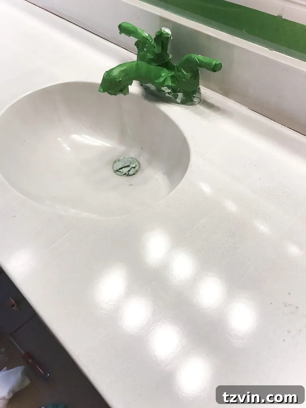 Transform Your Bathroom Counter with Paint 14 first coat of sink paint applied to edges