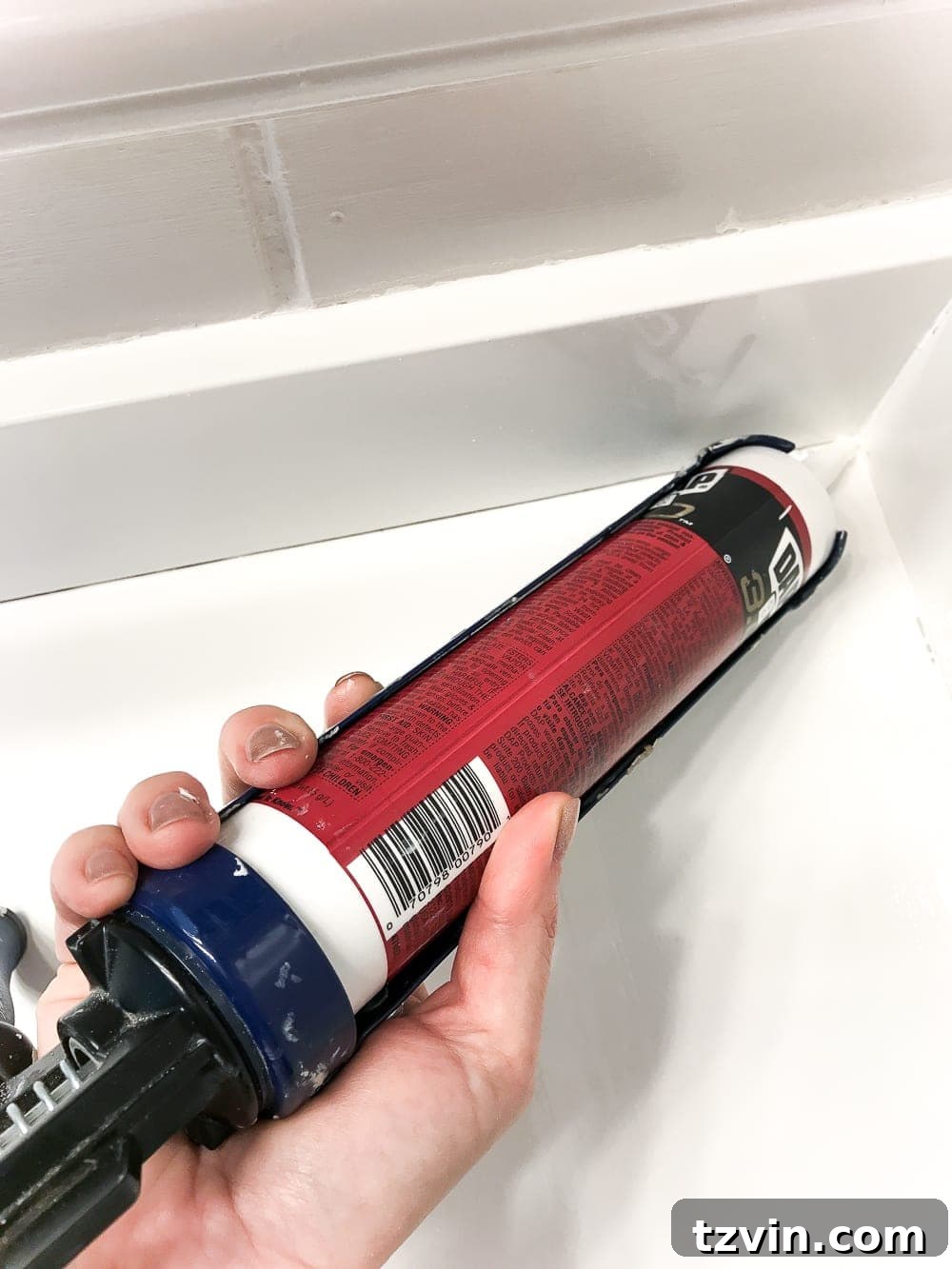 Transform Your Bathroom Counter with Paint 18 using silicone caulk to seal any cracks or edges on a newly painted countertop