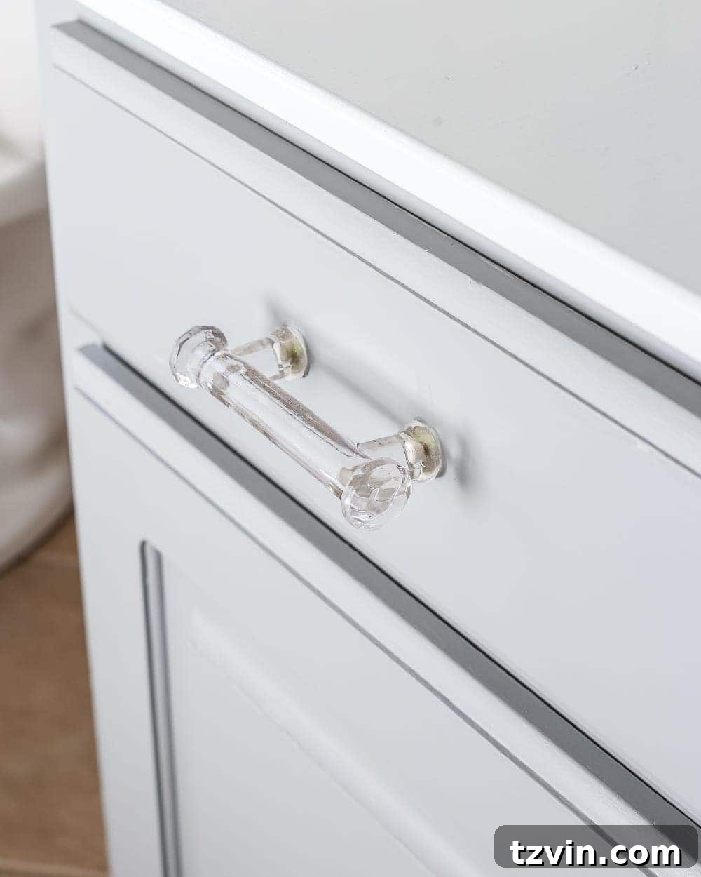 Detail of Glass Pulls on Benjamin Moore Coventry Gray Bathroom Cabinets - Reflecting the light and adding sophistication.