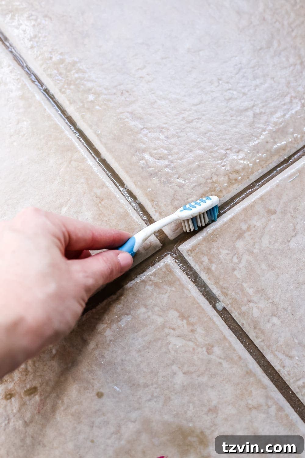Renewing Painted Tile Grout 4 Cleaning Bathroom Tile Grout with an Old Toothbrush and All-Purpose Cleaner - Step-by-step DIY.