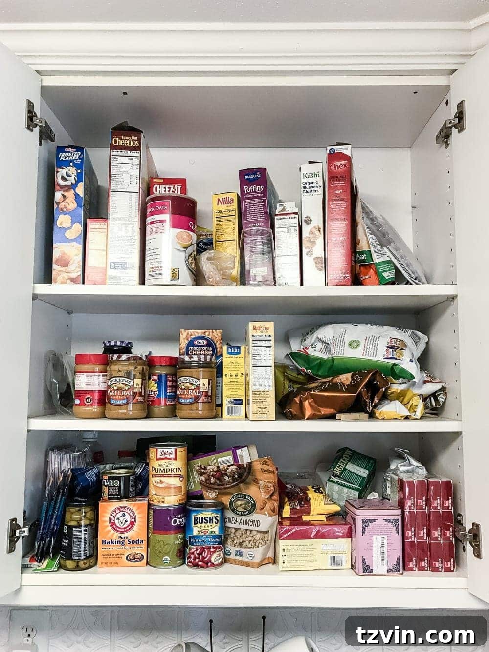 Pantry Cabinet Organization and Free Printable Label Set | blesserhouse.com - A cabinet gets a drastic organization makeover using inexpensive IKEA jars / baskets, hanging storage, and a free pantry label printable set. #organization 