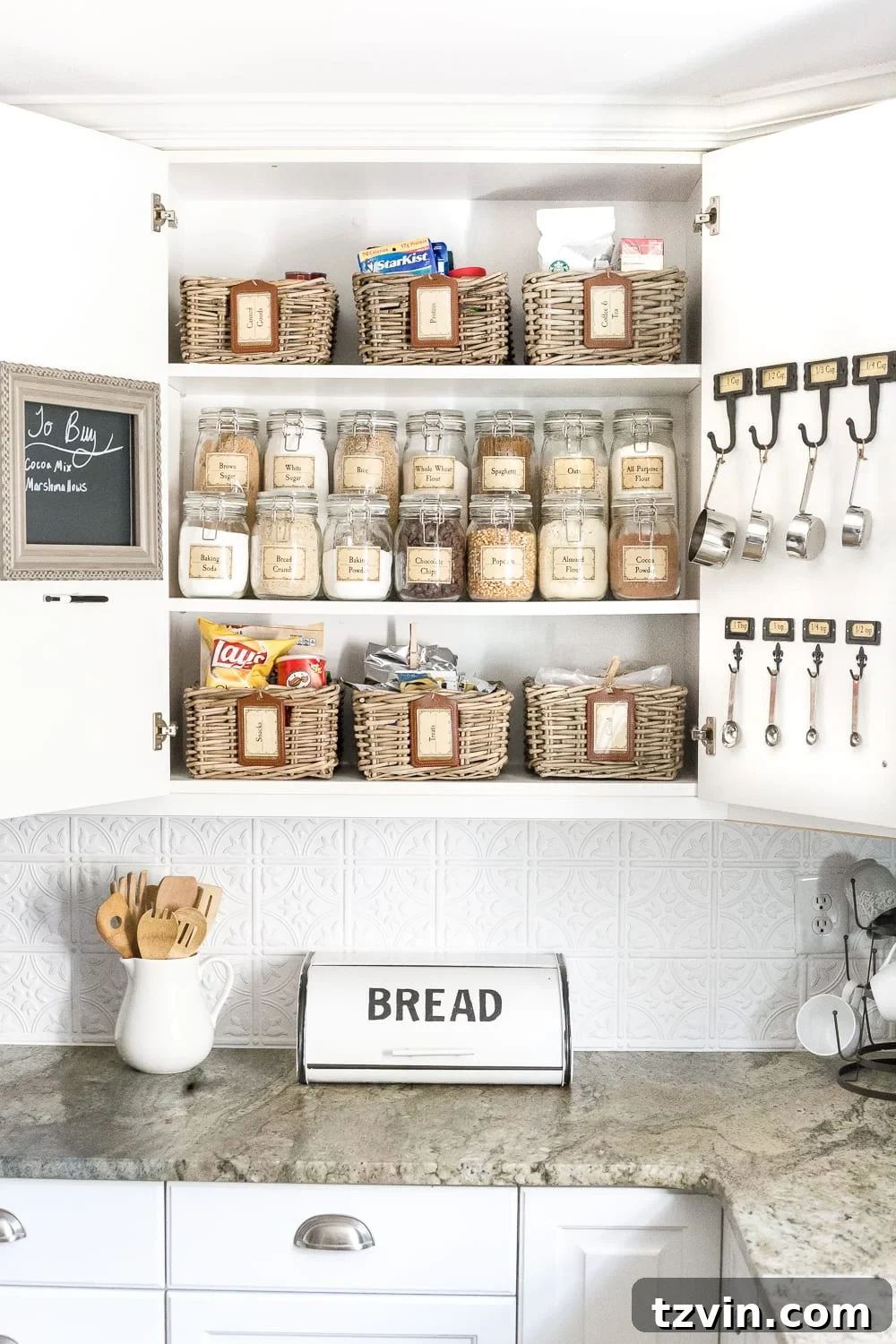 Pantry Cabinet Organization and Free Printable Label Set | blesserhouse.com - A cabinet gets a drastic organization makeover using inexpensive IKEA jars / baskets, hanging storage, and a free pantry label printable set. #organization 