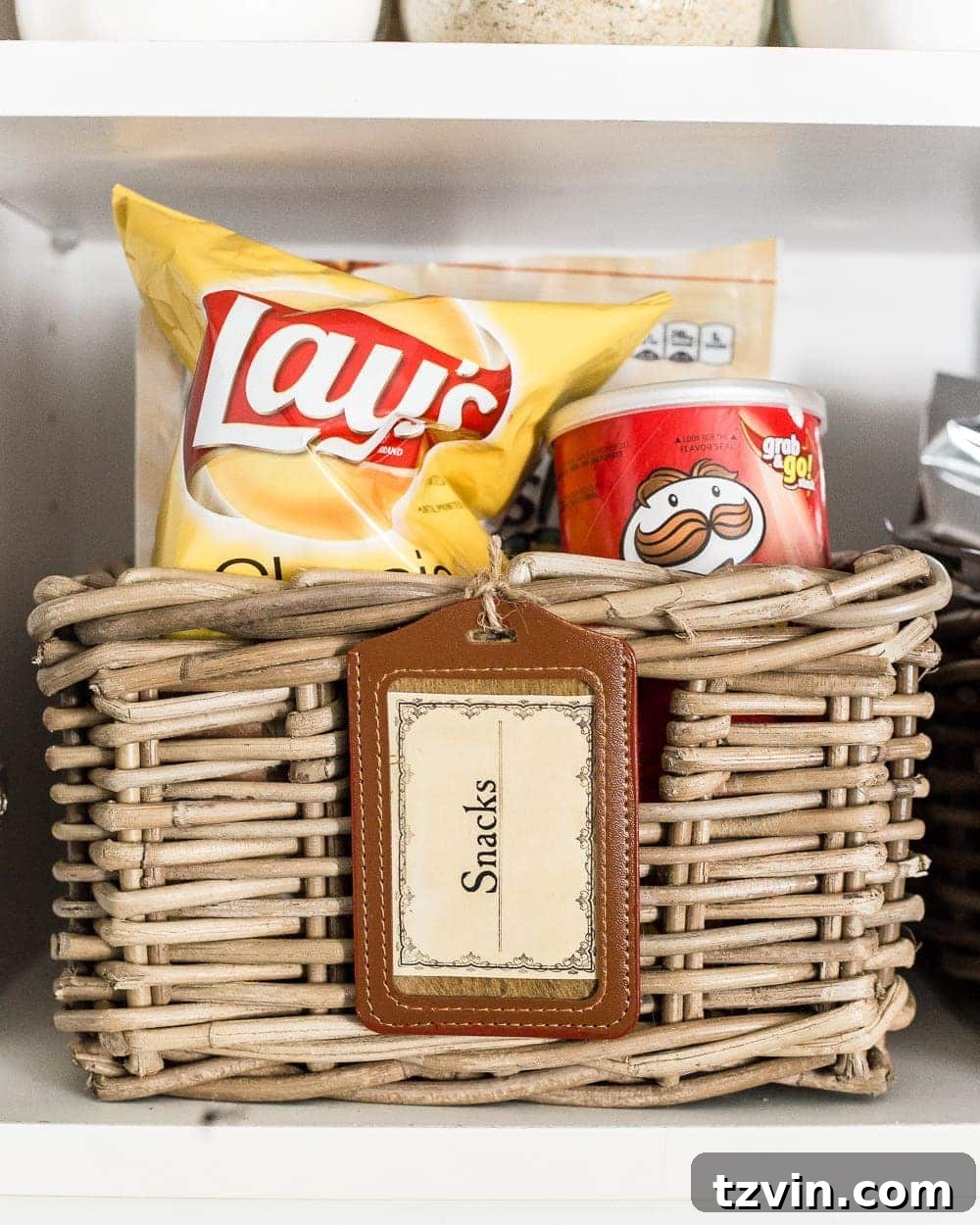 Pantry Cabinet Organization and Free Printable Label Set | blesserhouse.com - A cabinet gets a drastic organization makeover using inexpensive IKEA jars / baskets, hanging storage, and a free pantry label printable set. #organization 