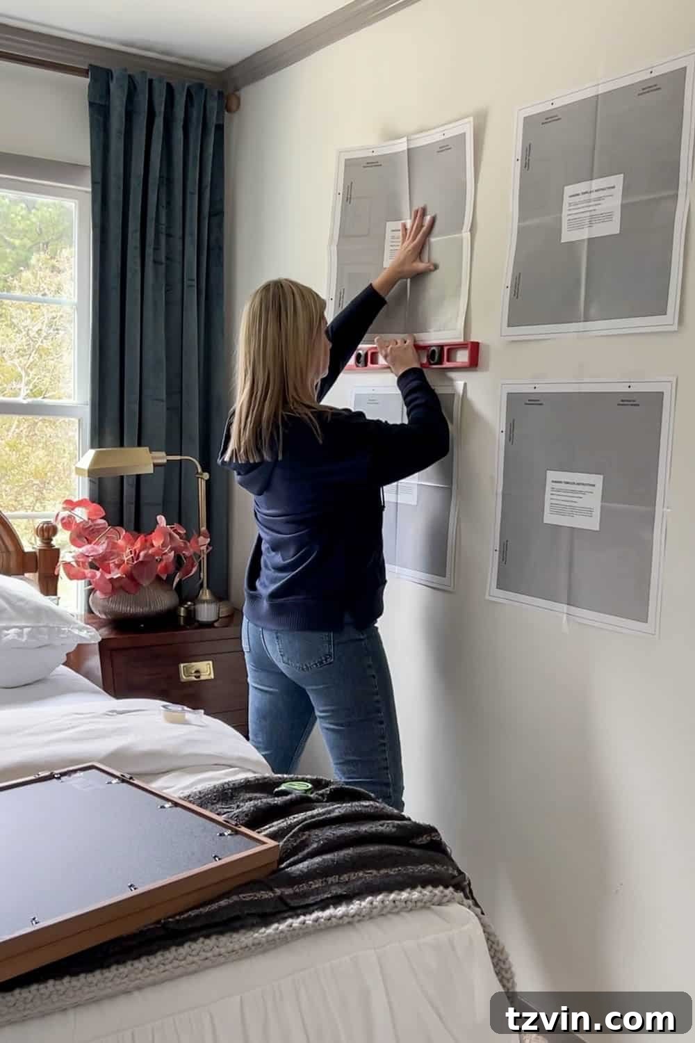 Perfect Gallery Wall Installation 19 checking picture frame templates to make sure they are level