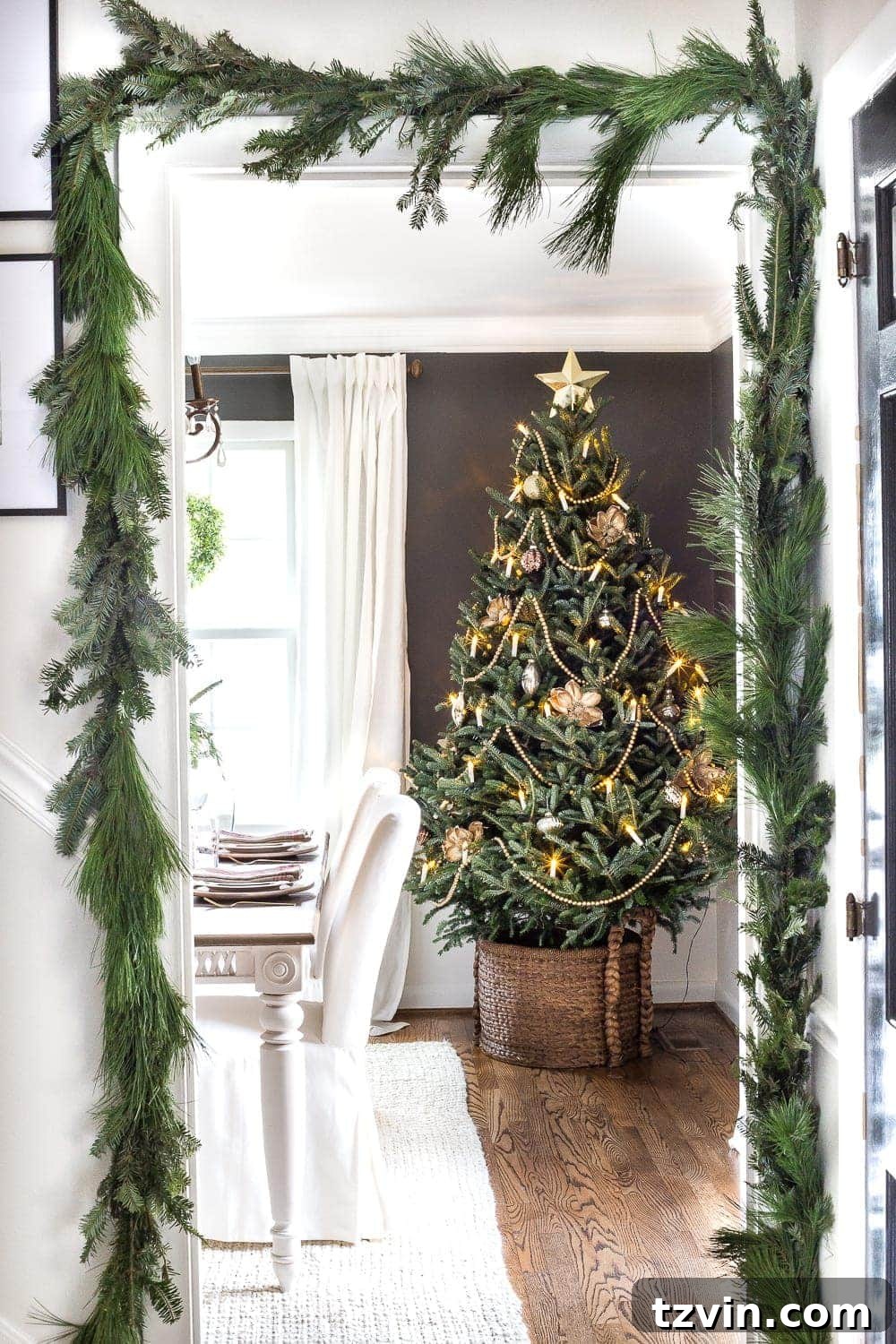 Live Christmas tree in dining room and real pine garland surrounding doorway