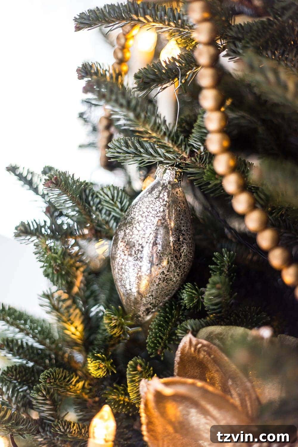 mercury glass ornament on a tree branch