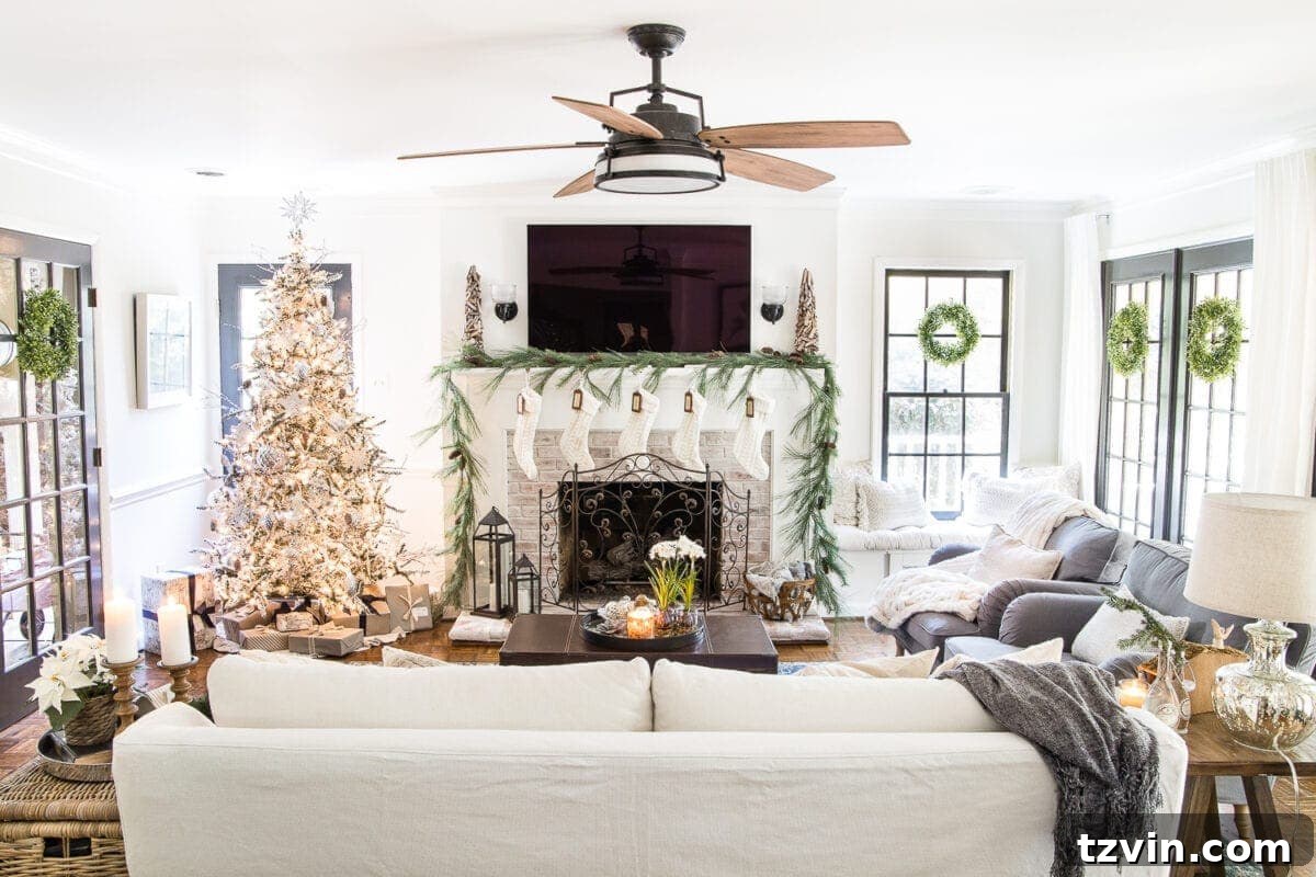 Cozy neutral Christmas living room with a decorated tree, natural garland, and warm lighting, embodying seasonal simplicity.