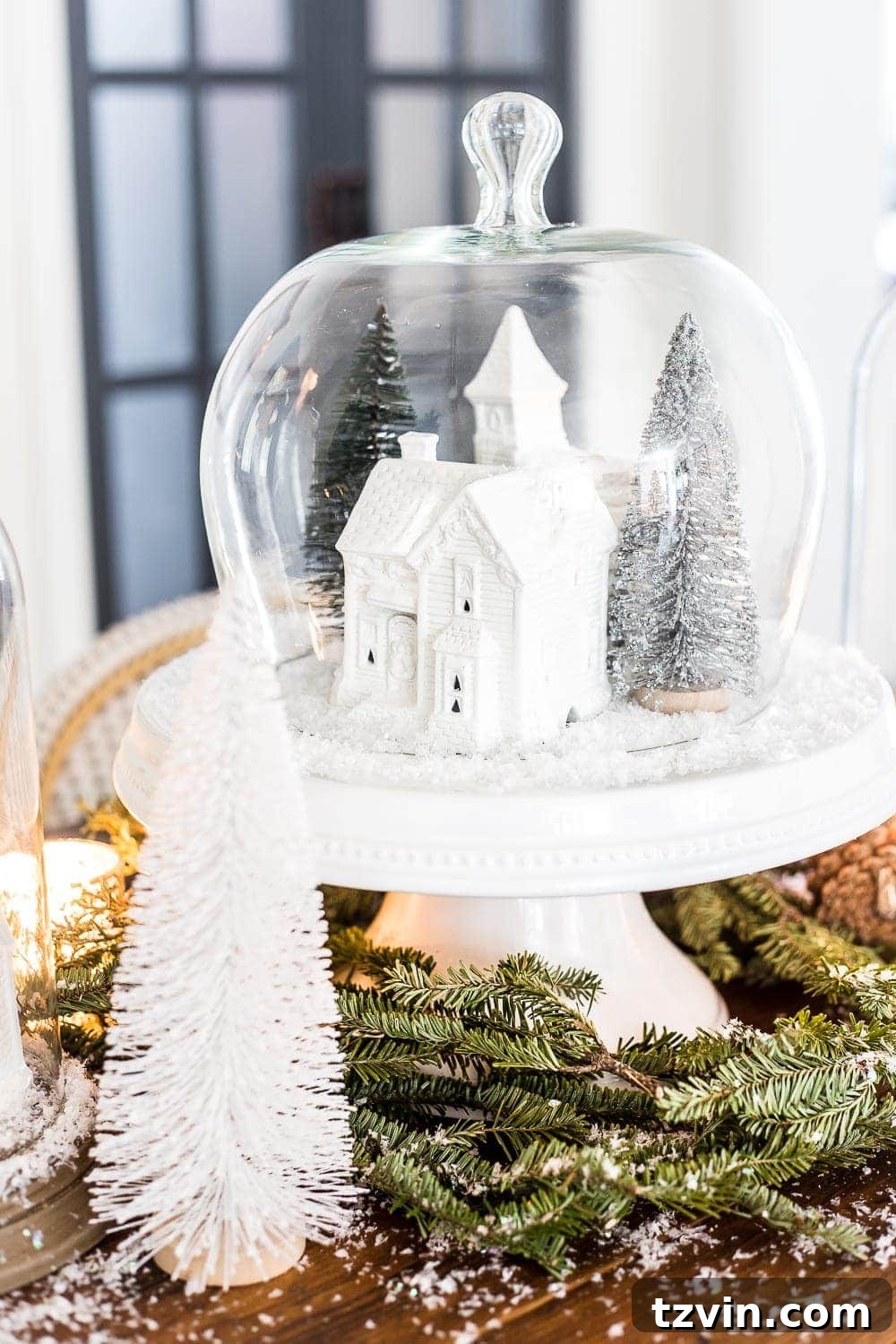 A charming Christmas village display with white houses and natural elements, adding a festive touch to the breakfast nook.